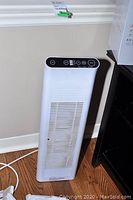 Front and top view showing control buttons and ventilation grille of Ionic Pro air purifier