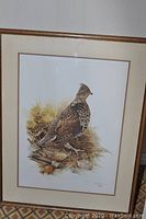 Full view of framed print showing whistling swan bird, artist signature and numbering visible near bottom right.