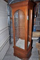 Full view of Kroehler wood and glass display cabinet with visible glass shelves and wood finish.
