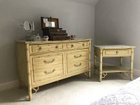 Front view of dresser and matching nightstand with decorative items on top.