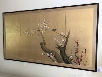 Front view of four-panel Japanese folding screen hung above sofa
