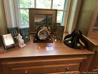 Overall display of painting, clock, bookends, card, figurine, croquet set on wooden table