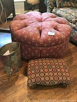 Photo showing all three items: large round ottoman, small footstool, and decorative trashcan on wood floor near furniture.