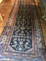 Full length view of the oriental runner rug on hardwood floor.