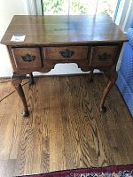 Front view showing three drawers and cabriole legs