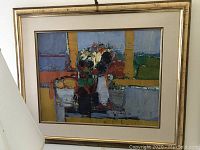 Full view of framed oil painting with linen mat and gold-leaf wood frame, partial spotlight visible