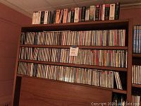 Top shelf with cassette tapes above two rows of audio CDs