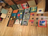 Photo showing a variety of vintage 78 RPM record albums and folios spread out on wood floor, highlighted by classical and Christmas themes.
