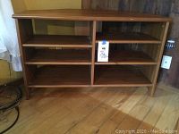 Front and top view of wooden corner media stand showing shelving and overall condition.