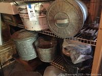 Metal containers and plastic wrapped items on metal shelving