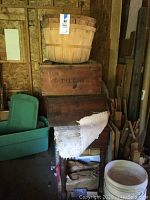 Overall grouping of two wooden bushel baskets, two vintage wooden boxes, and small wooden table or desk.