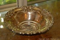 Angled view of bowl showing ornate decorative edging