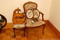 Embroidered wood framed chair with floral upholstery, wooden magazine rack with swan design and six framed embroidered bird pictures on chair seat