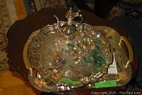 Overall view of rectangular tray with gold-tone handles, round tray, ewer, teaspoons and forks/picks