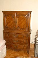 Full view of Thomasville solid wood wardrobe with upper cabinet doors and lower drawers