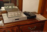 All three audio units arranged on wooden surface under mirror: Lafayette amplifier, Audiolab CD player, TEAC USB amplifier.