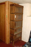 Front view of five-tier barrister bookcase showing stacked sections and glass doors