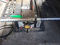 Partial side and top view showing power cord and part of the table saw body.