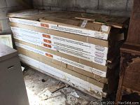 Twelve unopened cartons of wood flooring stacked in storage area