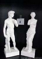 Front view of Venus de Milo and David porcelain statuettes side by side showing detailed sculpting and size relation.
