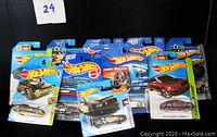Photo showing a group of Hot Wheels cars in original packaging arranged in rows.
