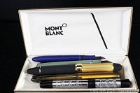 Five fountain pens inside a white lined Montblanc Meisterstuck hard case with logo
