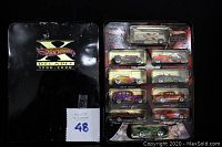 Set of 10 Hot Wheels cars inside the black metal collector's tin.