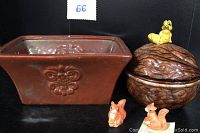 Photo showing rust brown ceramic planter next to walnut-shaped trinket box with squirrel on top plus two miniature squirrel figurines