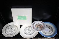 Five collector plates shown. The three Zodiac Calendar plates have black and white designs with zodiac signs and years 1977, 1979, and 1982. A white box is included with green label.