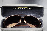 Serengeti large aviator sunglasses inside black hard case showing Serengeti logo on interior lid.