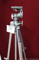 Close-up side view of Velbon VE 3 tripod showing the gear-driven center shaft, panhead, adjustment knobs, and Velbon label on leg.