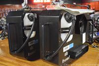 Two black Chauvet Vesuvio II units side by side with white fluid tanks and hoses