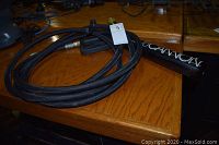 Barrel of Club Cannon and coiled hose on wooden table