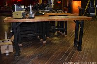 Solid wood bar table side view showing wood top and metal legs
