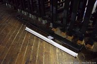 Two metal screen housings laid on wooden floor showing relative lengths and casings