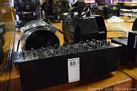 Front view of black Allen & Heath mixer showing channels, knobs and faders