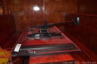 Plasma TV face down on table showing rear panel and attached wall mount bracket