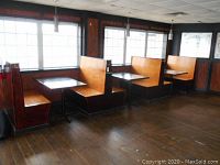 Four wooden booth benches (2 single, 2 double) arranged in a room with windows, showing overall layout and condition.