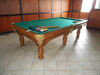 Full view of Dufferin Games pool table with green felt, balls racked, triangle racks on top