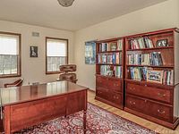 Photo of the cherry finish bookcase in a room with another matching bookcase, showing overall size and color.