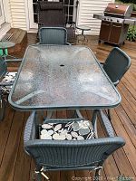 Overhead view of full patio set showing table and four chairs on deck