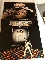 Two vinyl records side by side: Donna Summer's Live and More and Saturday Night Fever soundtrack showing front covers.