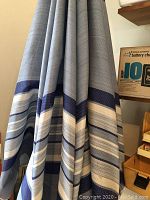 Close-up of the umbrella fabric showing blue and white stripes.