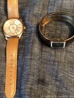 Bronzo Italia watch with tan leather strap and R.J. Graziano metallic bracelet placed side by side.