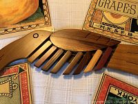 Close-up of the wooden parrot-shaped trivet showing detail and wood tones.
