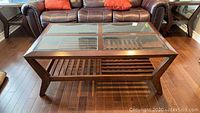 Full top view of the rectangular wooden coffee table with beveled glass top, showing some wear and scratches.