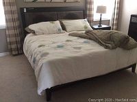 Full view of king size bed assembled in room with bedding