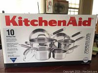 Front of unopened KitchenAid box showing graphic of 10-piece stainless steel cookware set