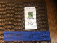 Photo showing auction lot label with dimensions handwritten: 107 inches by 72 inches.