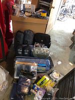 Overview of camping items: backpack, sleeping pad, pillow pockets, solar charger, footprints, plastic cases